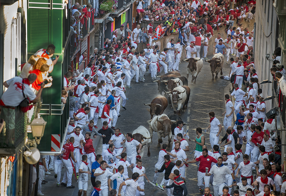 Men running with, and from, the bulls of Pamplona, Spain during the Festival of San Fermin on July 10, 2015. ©2015 Robert W. Hart